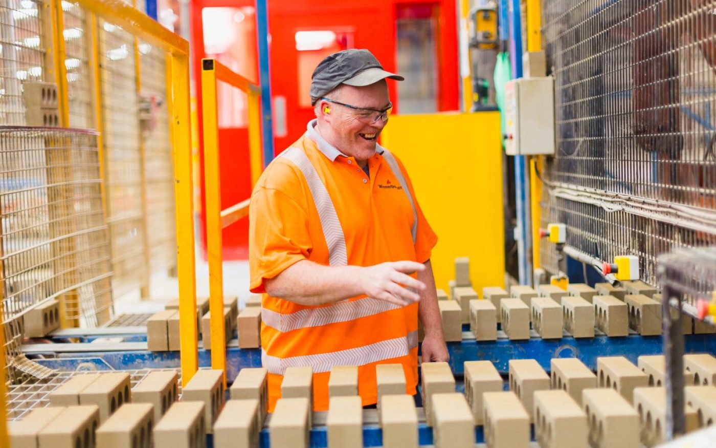 Man in Wienerberger factory on production line of bricks
