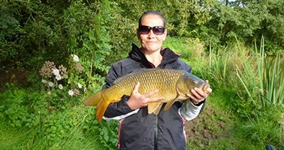 Wienerberger employee Tracy Davey holding a fish