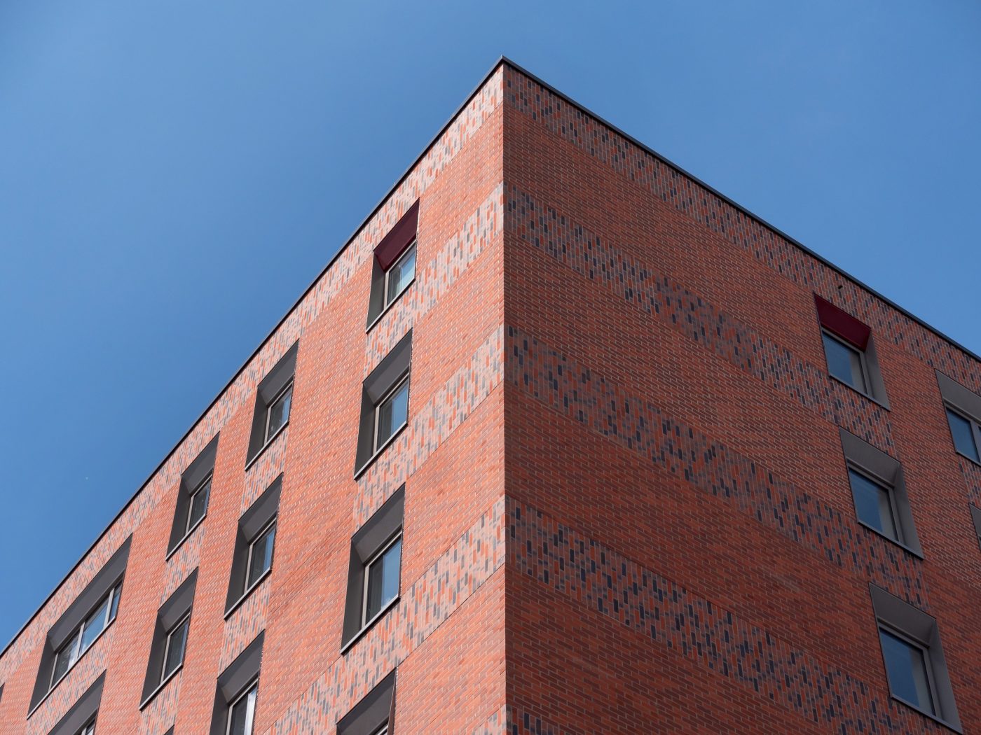 Corner of modern building with brick tile cladding