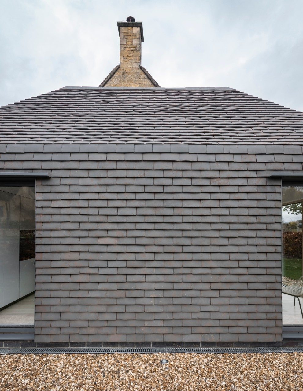Side view of modern extension with bespoke vertical tiling