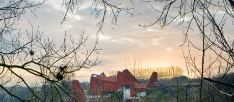 The unique red roof buildings in the distance at sunset