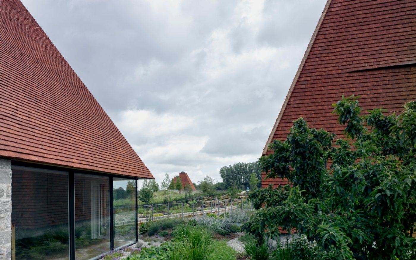 Large red roof with big glass windows around the building