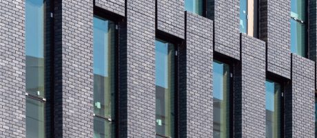 Close up of dark grey facade of multi-storey building