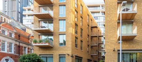 multi-storey yellow brick complex with balconies
