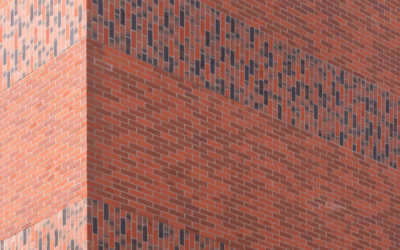 Close-up of blend of red and grey Corium brick tiles on corner